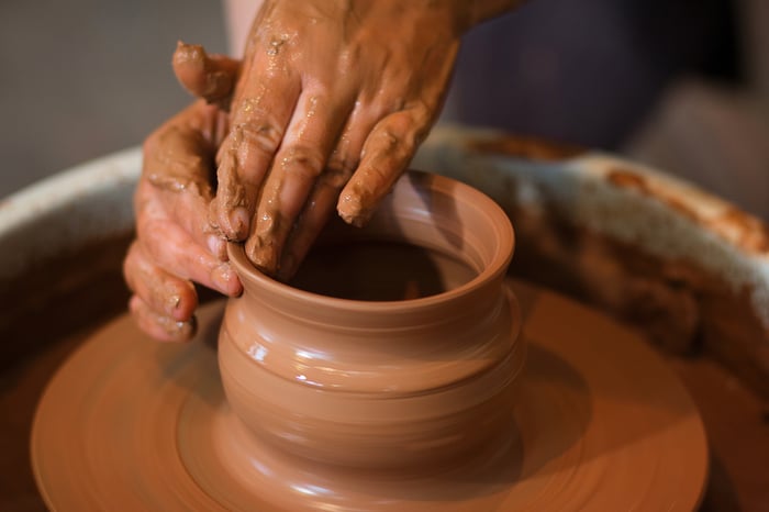 bigstock-Rotating-Potters-Wheel-And-Cla-293734447